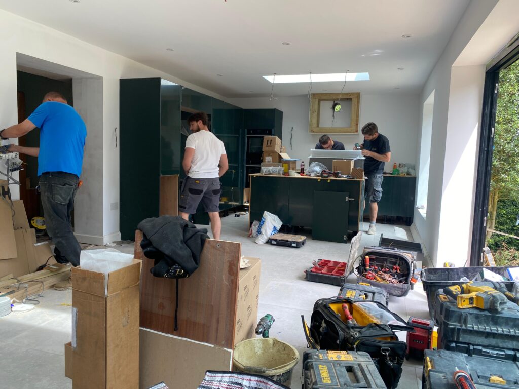 builders working on installation of a kitchen